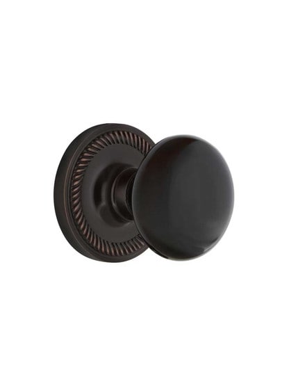 Rope Rosette Door Set with Black Porcelain Knobs in Timeless Bronze.